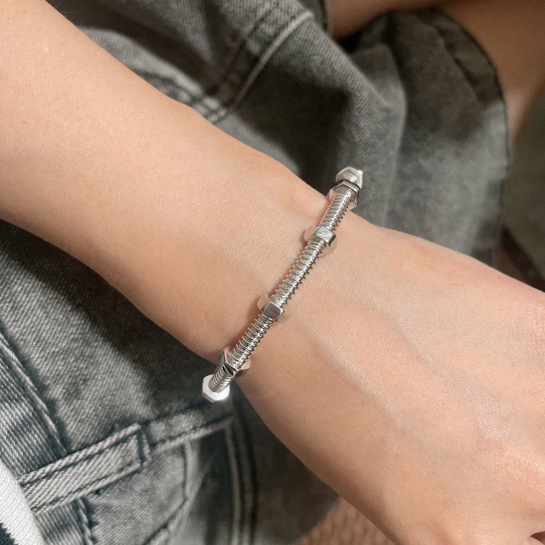 Silver flexible screw bangle worn on wrist